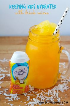 a mason jar filled with orange juice and coconut flakes