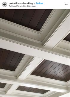 the ceiling in this room has wooden paneling on it and is painted white with brown trim