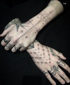 two hands that have tattoos on them, one with an arrow and the other with stars