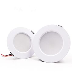 two white downlights with red wires on the side and one in the middle, both facing each other