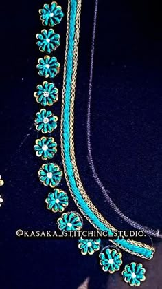 a blue necklace with flowers and chains on it