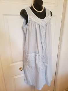 "Cool and Feminine Nightgown/House Dress Basic Editions  Size M Pretty Shiny White Lace Trim shoulder to shoulder 13 inches underarm across 21 inches shoulder to hem is 40 inches Size M Sleeveless, knee length and a Handy large Pocket! Cool, pretty and comfy Wear as a lounge or Day/House Dress. Front dome buttons ZOOM into pictures to appreciate the detail. If you have any questions please email me These rescued items have been  once loved.   They may show some signs of discoloration or a loose thread here and there  which add to the charm of Vintage which you can not find in \"new\". Any noticed flaws are listed and Vintage is sold \"as is. Perfectly imperfect! for more lovely viewings please visit: https://www.etsy.com/ca/shop/LovelyThingsBtqShop" Sleeveless Cotton Sleep Dress, Casual Sleeveless Nightgown With Lace Trim, Casual Sleeveless Lace Trim Nightgown, Sleeveless Sleepwear For Spring At Home, Sleeveless Sleepwear For Home In Spring, Sleeveless Sleepwear For Spring, Summer Sleeveless Nightgown For Home, Cotton Sleeveless Sleepwear For Home, Cotton Sleeveless Sleepwear