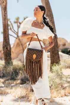 Compact, versatile and cleverly designed with an exterior easy access pocket, the World Traveler is an ideal go-everywhere bag. This messenger-style look is lightweight and roomy yet emanates effortless boho-chic. Dimensions: Medium: Width: 7"x Height: 7" Depth: 2.25"Large: Width: 9.5"x Height: 9.5" Depth: 3"Fringe Length: 12" Strap Options Option 1: (NEW!) Adjustable crossbody strap that can adjust from 30" to 57"Option 2: 47" Crossbody strapOption 3: 47" Crossbody strap and 17" shorty round br Vintage Designer Bags, Fringe Handbags, Boho Handbags, Blonde With Pink, Women's Bags By Style, Boho Fringe, Fringe Bags, Boho Bags, Dirty Blonde