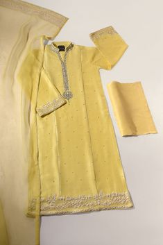 Designed on pure lemon yellow raw silk 60 gms, with silver hand/ada work, with organza appliqué embroidered borders on flair full sleeves and damaan back and front. Style with matching flappers and an orgwnza dupatta featuring embroidered borders with clusters of pearls. The length of the long kameez is 48 inches. Orde Long Kameez, Ethenic Wear, Heavy Dupatta, Lace Dress Design, Traditional Indian Dress, Pakistani Fancy Dresses, Kurta Dress, Salwar Kamiz, Loafer Shoes Women