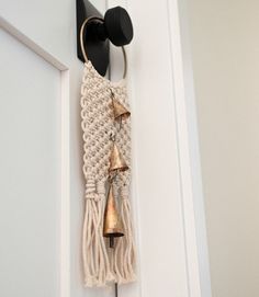 a wall hanging with two bells attached to it