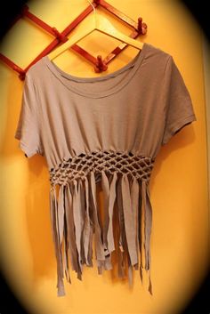 a t - shirt with fringes hanging on a wall