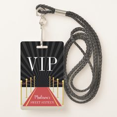 a black lanyard with a red carpet on it and a name tag attached to the lanyard