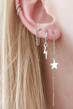 a close up of a person with ear piercings on their ears and one behind the ear