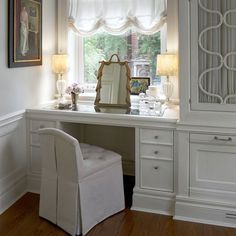 a white desk and chair in front of a window