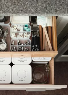 an organized kitchen drawer with dishes and utensils