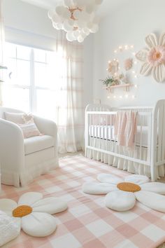 a pink and white baby's room with flowers on the floor, crib