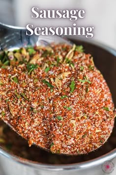 a spoon full of seasoning on top of a metal bowl with the words sausage seasoning