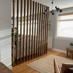 a living room filled with furniture and wooden slats