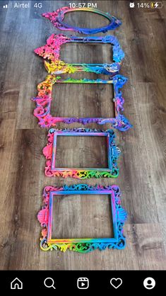 four colorful frames sitting on top of a wooden floor