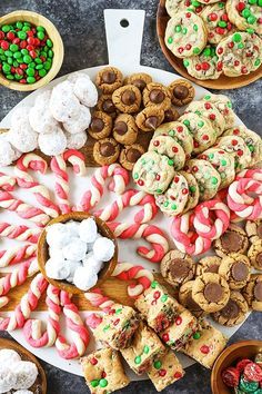 an assortment of cookies and candy on a platter