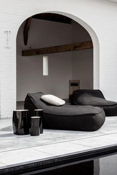 a black and white living room with an arch