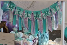 a table topped with lots of bags filled with candy and confetti next to candles