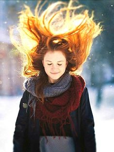 a woman with her hair flying in the air