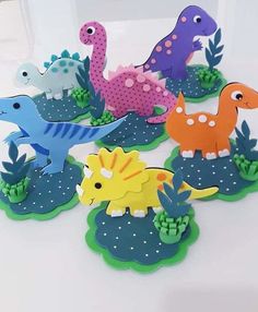 dinosaur cut outs are sitting on the table