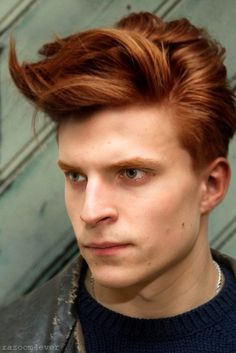 a man with red hair wearing a leather jacket