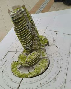 a model of a tall building with lots of green plants growing out of it's sides