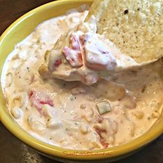 a yellow bowl filled with dip and chips