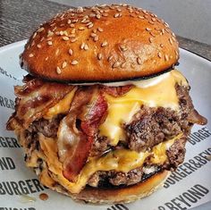 a cheeseburger with meat and bacon is on a plate