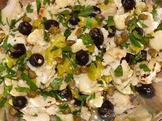 a close up of a plate of food with chicken and olives