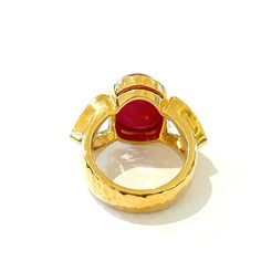 This is part of Chairish’s Fine Jewelry assortment.  Red natural ruby, Oval cabochon shape - 13 carats White natural topaz, 7 carats  This Ring is from the "Orient" traveling collection are the epitome of elegance and versatility. It offers a perfect blend of day to night and swimwear to evening wear, allowing you to effortlessly transition between different occasions and outfits. Wearing these spectacular oriental-style ring will undoubtedly make you the center of attention. It addw a touch of Luxury Red Cabochon Ruby Ring, Luxury Ruby Ring With Oval Cabochon, Luxury Ruby Ring With Cabochon Cut, Luxury Ruby Ring Oval Cabochon Polished Finish, Luxury Ruby Oval Cabochon Ring, Luxury Ruby Ring Oval Cabochon, Luxury Ruby Rings With Gemstone Accents, Luxury Ruby Ring With Oval Cabochon And Polished Finish, Luxury Ruby Ring Oval Cabochon With Polished Finish