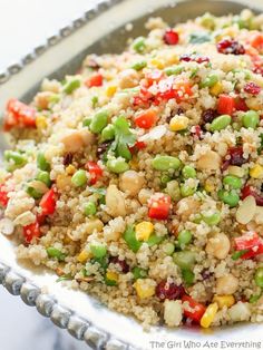 a bowl filled with rice and vegetables on top of a table