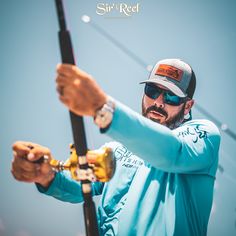 a man holding onto a fishing pole while wearing sunglasses and a hat with the words sir reed on it