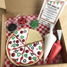 an open box with pizza and toppings on it