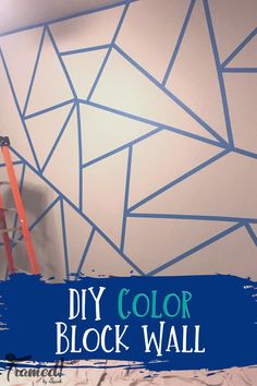 a man is painting a wall with blue paint on it and the words diy color block wall above him