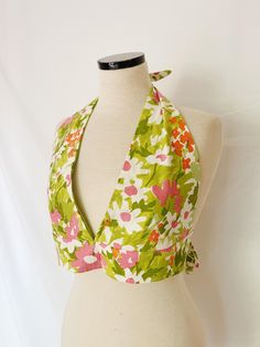 A batch of honey hole handmade goodies are now available in the shop-- our latest concept: halter tops made from vintage fabrics/materials.  This specific top is upcycled from a vintage tablecloth in a floral cotton, inside lined with a lime green. The self tie options at waist and neck allows top to fit a range of sizes from small to medium. Keep in mind the bust construction is designed for a B-C cup or larger to avoid gaping. Please note design/pattern may vary slightly due to cut of fabric. Retro Halter Top For Spring Beach Outing, Retro Halter Top For Beach In Spring, Vintage Cotton Tops For Garden Party, Multicolor Cotton Halter Top For Spring, Spring Multicolor Cotton Halter Top, Retro Triangle Halter Top For Summer, Retro Summer Triangle Halter Top, Retro Halter Neck Beach Top, Vintage Cotton Top For Picnic