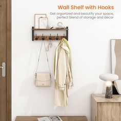 a wall shelf with hooks and purses hanging on it next to a wooden table