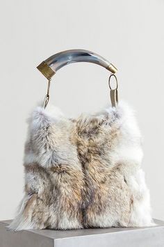 The Austin Fur Shoulder Bag goes wild in natural fur that looks and feels amazing, and packs some oomph into daytime or evening clothes. Free shipping   returns. Evening Clothes, Fur Purse, Fur Handbags, Coyote Fur, Cow Horns, Fur Bag, Mood Board Fashion, Fur Fashion, Cute Bags