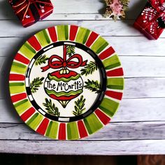 the merry plate is decorated with red, green and white ribbons on it's edge