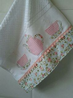 a white towel hanging on the wall next to a pink and white flowered pot