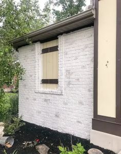 a white brick building with a small window