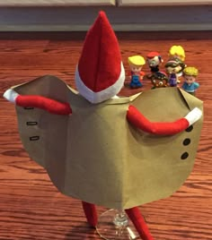 a paper bag with an elf's hat on top of it sitting on a table