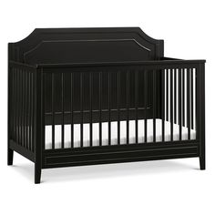 a black crib with white sheets on the bottom and side rails, in front of a white background