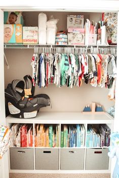 a baby's closet with clothes, diapers and cribs on the shelves