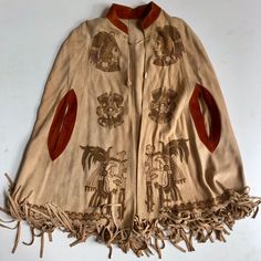 Vintage 60s 70s Suede Fringe Native American Poncho / Shawl Toggle Closure Arm Slits Fringe Along Hem Handcrafted Pyrography Artwork Along Front And Back Pyrography Or Pyrogravure Is The Free Handed Art Of Decorating Wood Or Other Materials With Burn Marks Resulting From The Controlled Application Of A Heated Object Such As A Poker. It Is Also Known As Pokerwork Or Wood Burning. The Term Means "Writing With Fire" Tags: Southwestern, Aztec, Native, Ceremonial, Retro, Western, Leather Suede, Artisan, Rodeo, Native American Indian, Handmade, Shawl, Cape, Unisex, Traditional Wild West Poncho, Traditional Fringe Poncho For Fall, Bohemian Fashion, Traditional Fall Poncho With Fringe, Traditional Fringed Poncho Shawl, Choctaw Indian, Vintage Poncho 1970s, Poncho Shawl, Cowboy Outfits