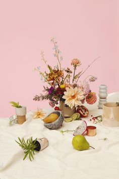 a table topped with lots of different types of flowers