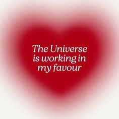 a red heart with the words, the universe is working in my favour