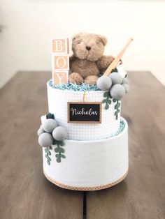 a teddy bear sitting on top of a cake