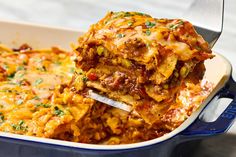 a casserole dish with meat and cheese being lifted from the casserole