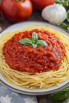 spaghetti with sauce and basil on a plate