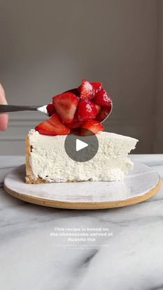 someone cutting into a piece of cheesecake with strawberries on top