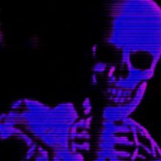 a skull with sunglasses and a cell phone in its hand is lit up by purple light